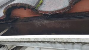 Tile roof eave closure flashing