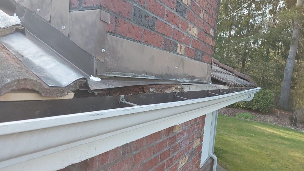 Finished chimney pan flashing replacement with the tiles back on in Langley.