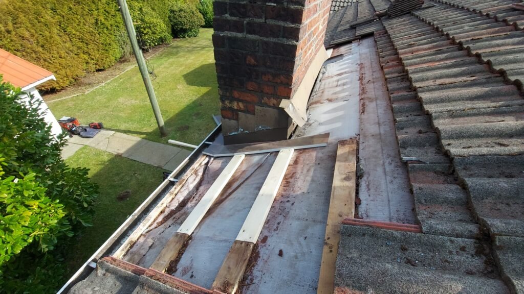 Replacing the wood battens around a chimney on a Langley tile roof.