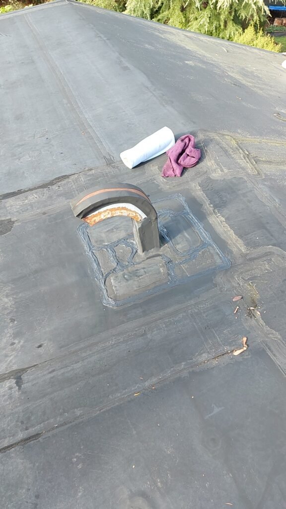 Close-up of an EPDM patch being sealed on a North Vancouver roof.