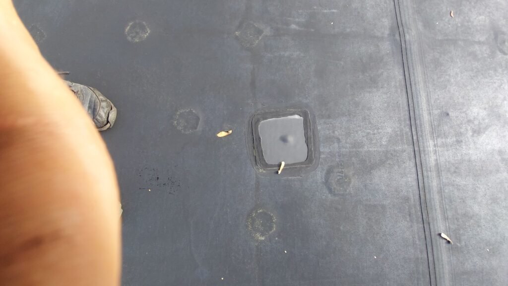 Patching a backed-out screw that poked through an EPDM membrane in North Vancouver.