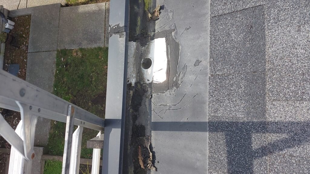 Hidden gutter drain sealed with caulking on a Richmond roof.