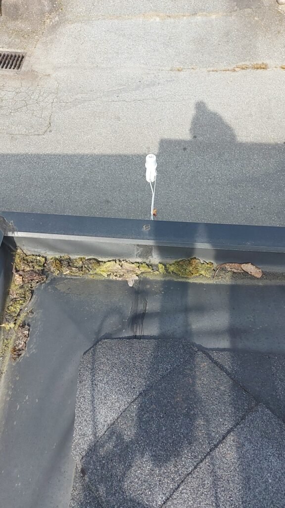 Nailed and caulked seam in a hidden gutter on a Richmond roof.