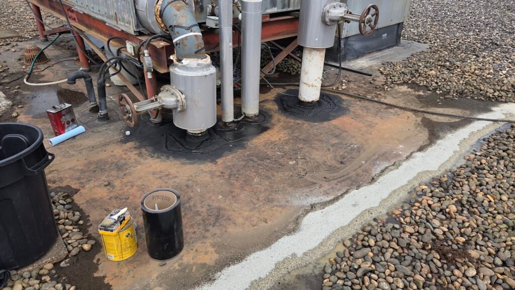 Commercial Flat Roof Leak Repair in Mission 5 Existing patches cleaned with fresh lap sealant applied around the edges on a commercial roof in Mission.