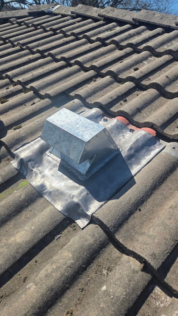 New lead-based gooseneck roof vent on a Vancouver tile roof.