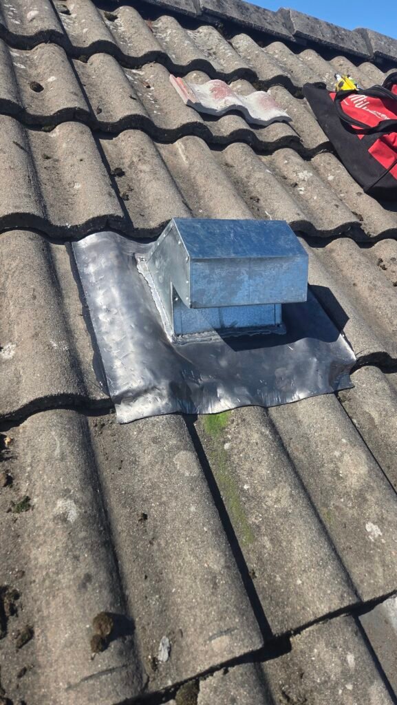 Finished lead gooseneck vent dressed into the tiles on a Vancouver roof.