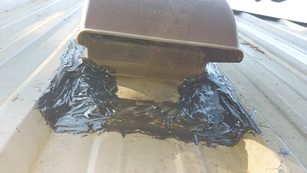 Metal Roof Vent Leak in Aldergrove: Why 50-Year Roofs Still Need Maintenance 3 Caulking around the base of a metal roof vent in Aldergrove.