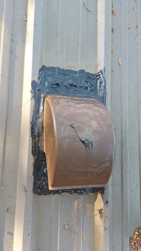 Metal Roof Vent Leak in Aldergrove: Why 50-Year Roofs Still Need Maintenance 4 Fresh caulking applied around a metal roof vent in Aldergrove.