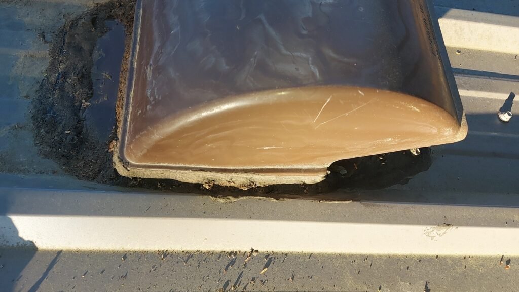 Metal Roof Vent Leak in Aldergrove: Why 50-Year Roofs Still Need Maintenance 2 Metal roof vent sealed only with caulking in Aldergrove.