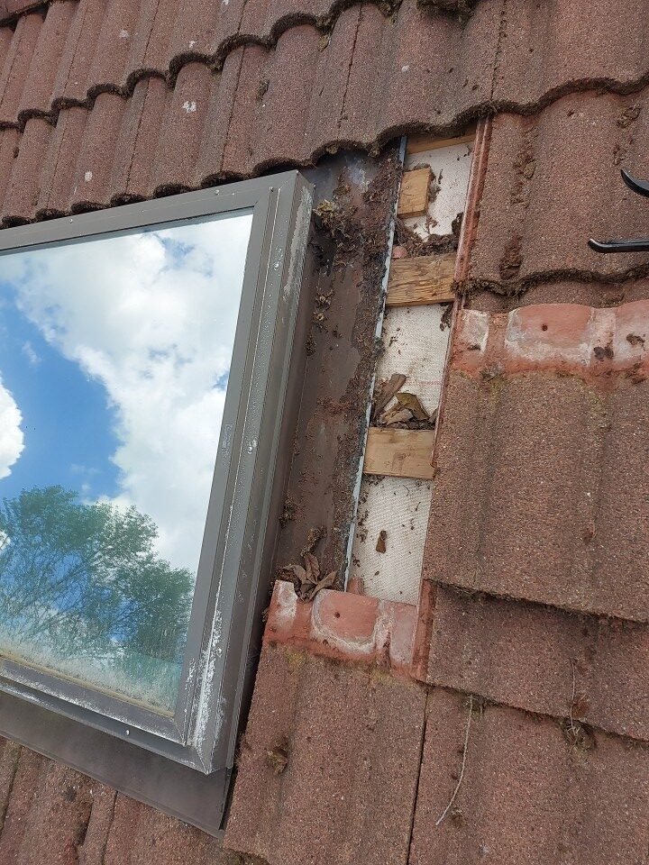 Concrete tiles reinstalled around the repaired skylight on a Port Moody roof under clear skies.