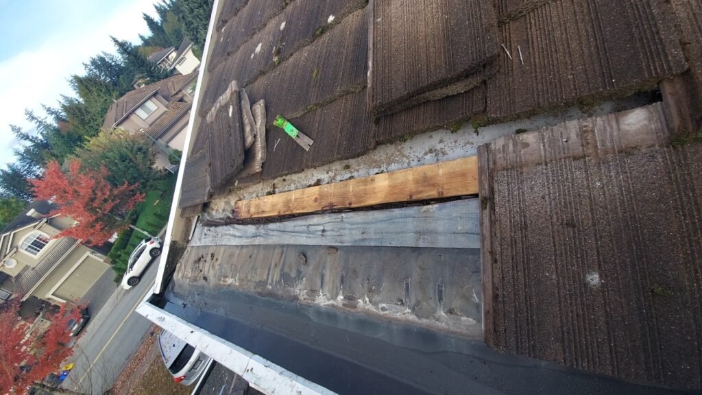 Eave of a Coquitlam tile roof with tiles removed, showing the underlay channel.