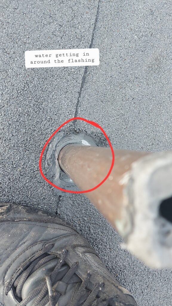 Failing flashing letting water in around a pipe penetration on a torch-on flat roof in Aldergrove.