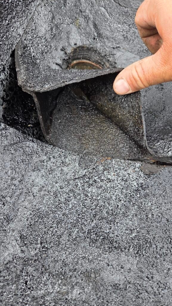 Water trapped between the plies of a torch-on roof at the drain in New Westminster.