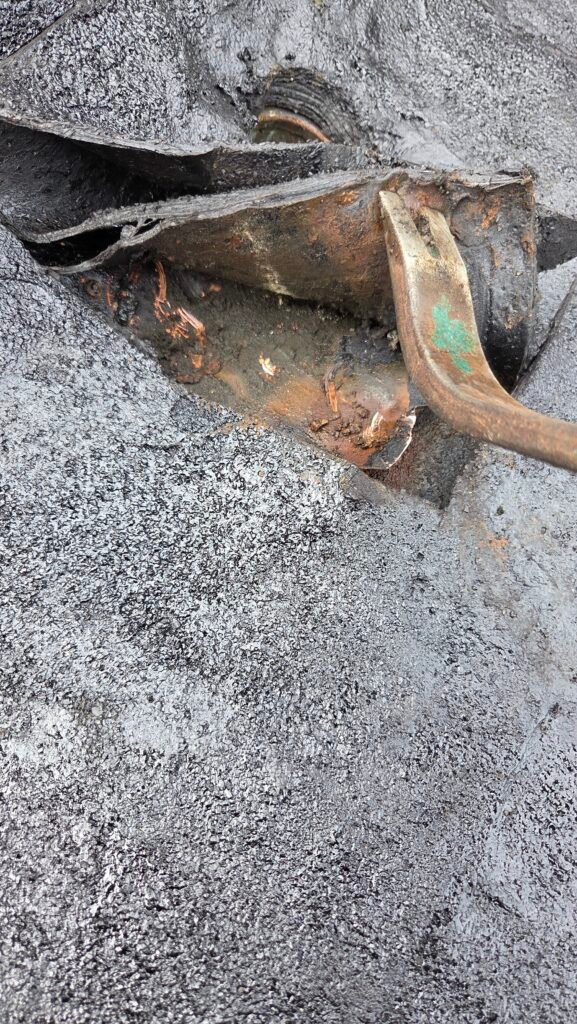 Wet copper drain flange under a torch-on roof membrane in New Westminster.