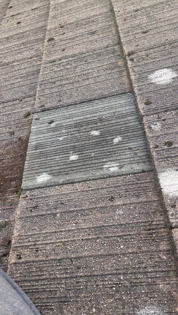 Broken Roof Tile Replacement in Coquitlam: Why We Use Recycled Columbia Tiles 3 A recycled Columbia concrete roof tile being installed to replace a broken tile on a Coquitlam roof.