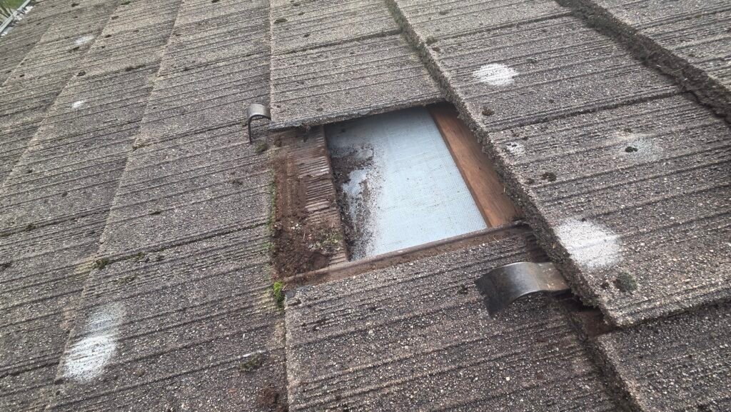Broken Roof Tile Replacement in Coquitlam: Why We Use Recycled Columbia Tiles 2 Pry bars lifting the roof tiles on each side of a broken tile so it can be removed on a Coquitlam tile roof.