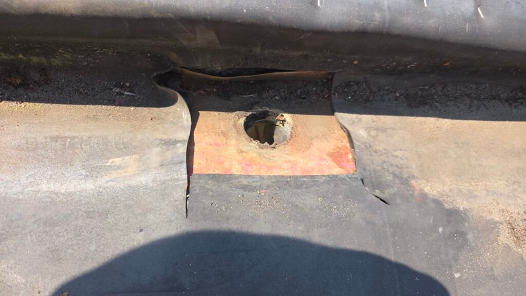 Hidden Gutter Drain Leak on a Coquitlam Tile Roof: Why the Drain Goes Over the Membrane 2 EPDM membrane cut back to expose the old copper drain flange, showing where the membrane came unbonded from the copper.