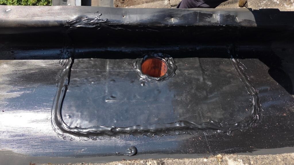 Hidden Gutter Drain Leak on a Coquitlam Tile Roof: Why the Drain Goes Over the Membrane 6 Elevate EPDM patch bonded over the new three inch drain with lap sealant applied around every edge.