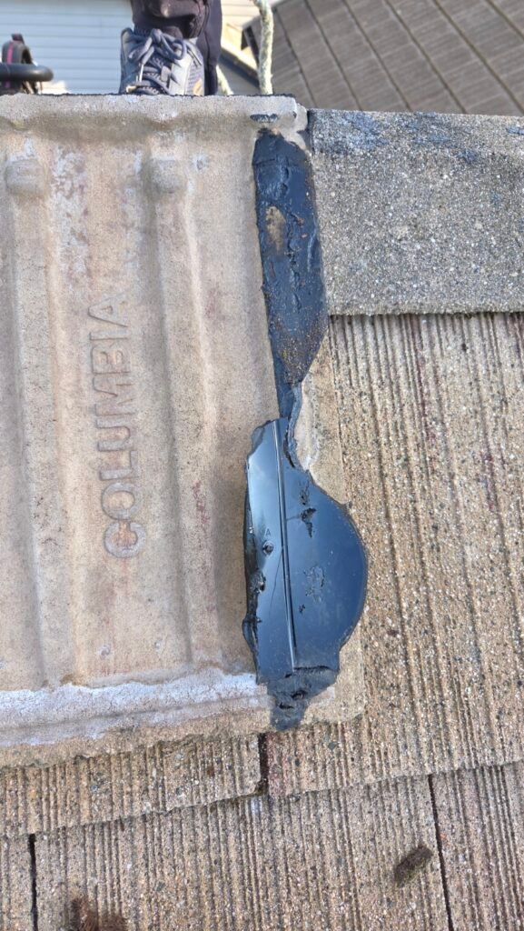 Roof mastic left stuck to a concrete Columbia roof tile after the bond to the plastic vent gave out.